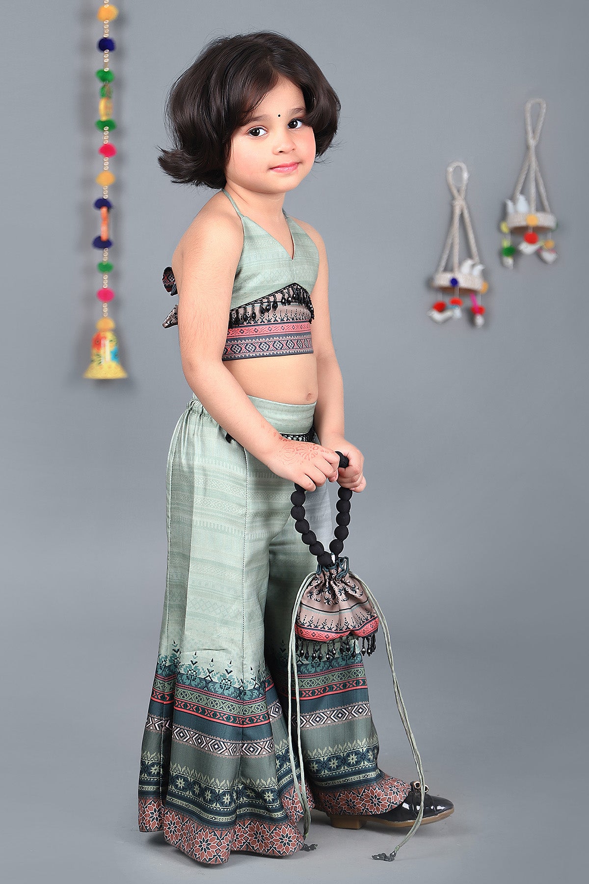 Halter neck top and pretty printed palazzo with potli bag