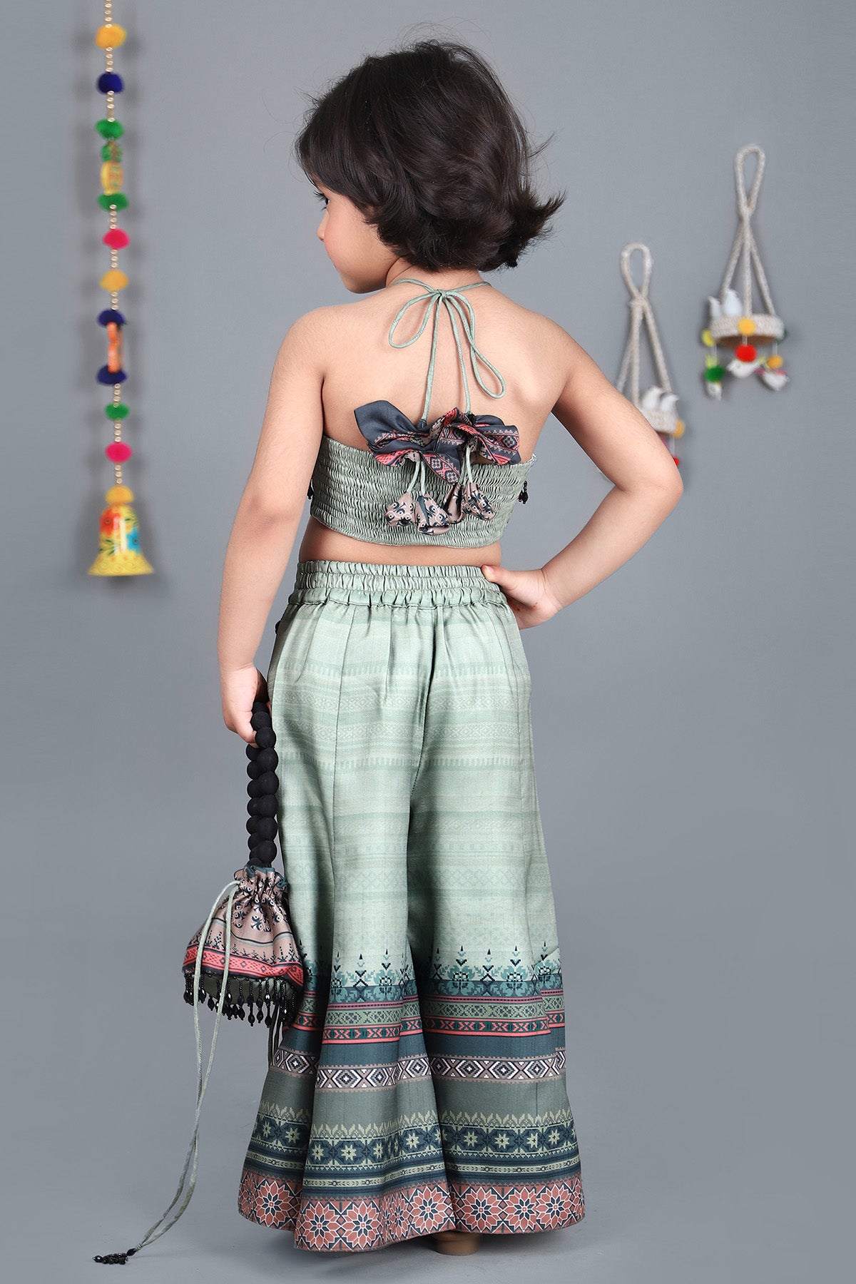 Halter neck top and pretty printed palazzo with potli bag