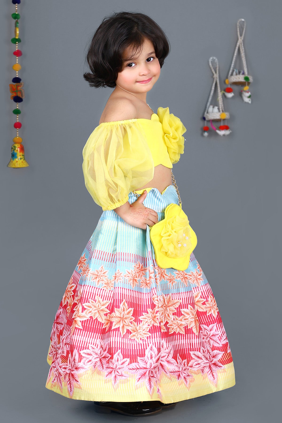 Yellow scalloped top and floral printed skirt with sling bag