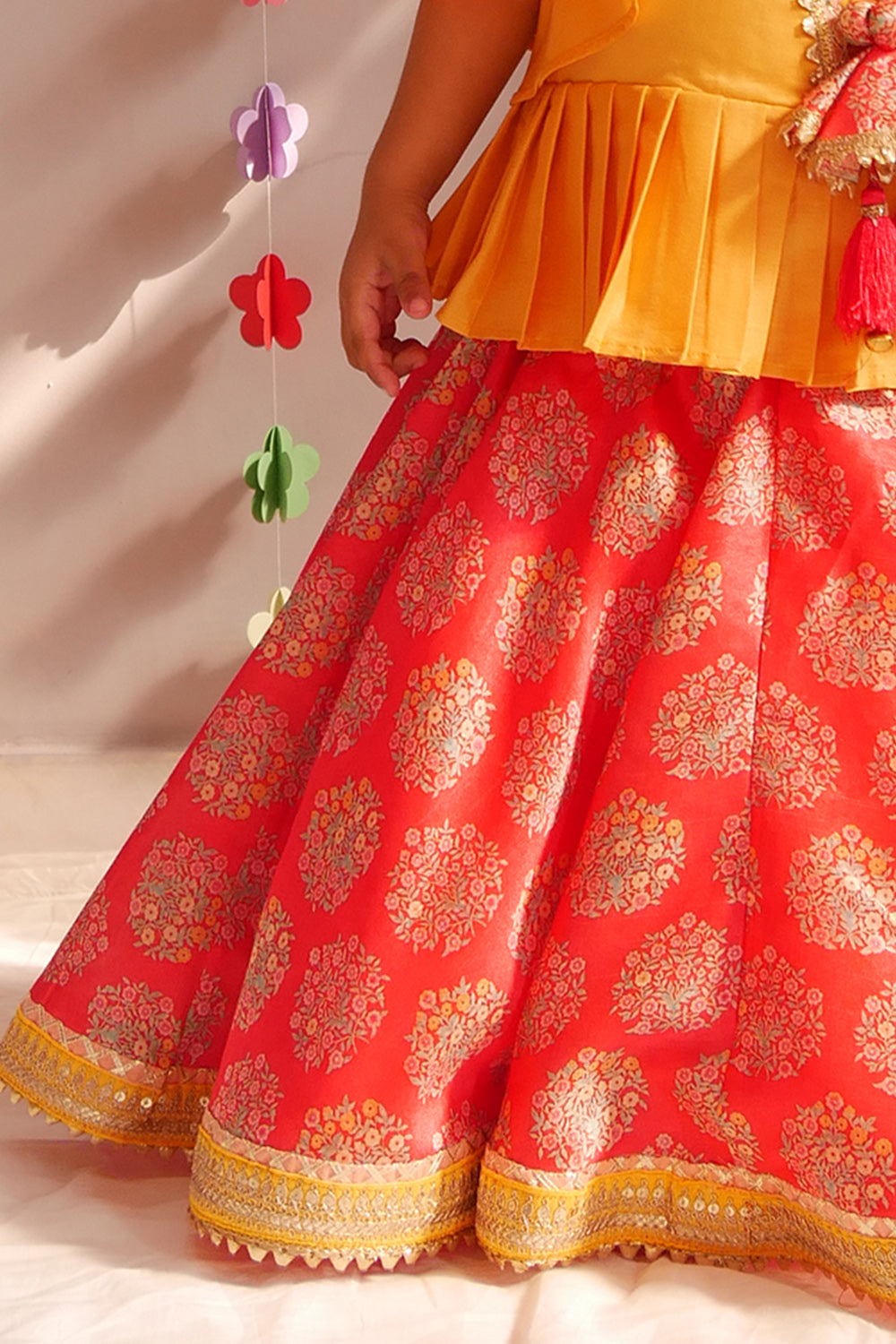 Yellow angrakha style top and red floral lehenga