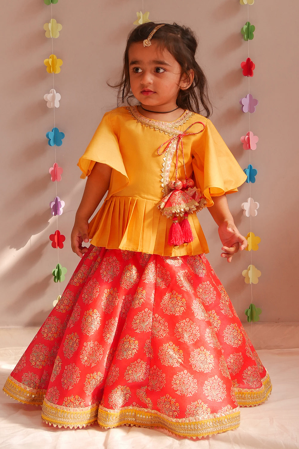 Yellow angrakha style top and red floral lehenga