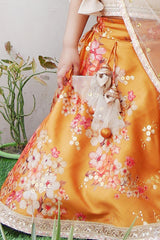 Golden beige top with attached dupatta and mustard floral lehenga